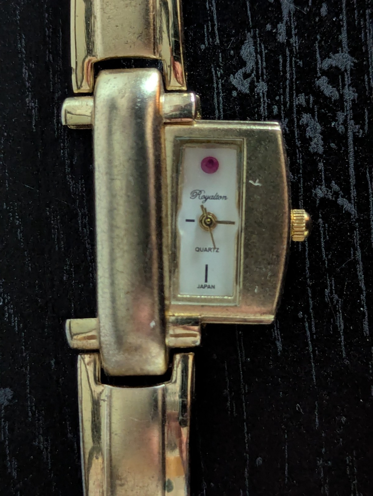 Gold plated watch by Royaltin with red crystal or Ruby not sure which. Very min