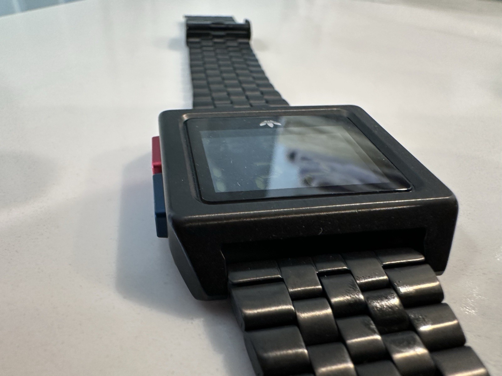 Adidas Archive M1 watch with a matte black finish and a square digital display