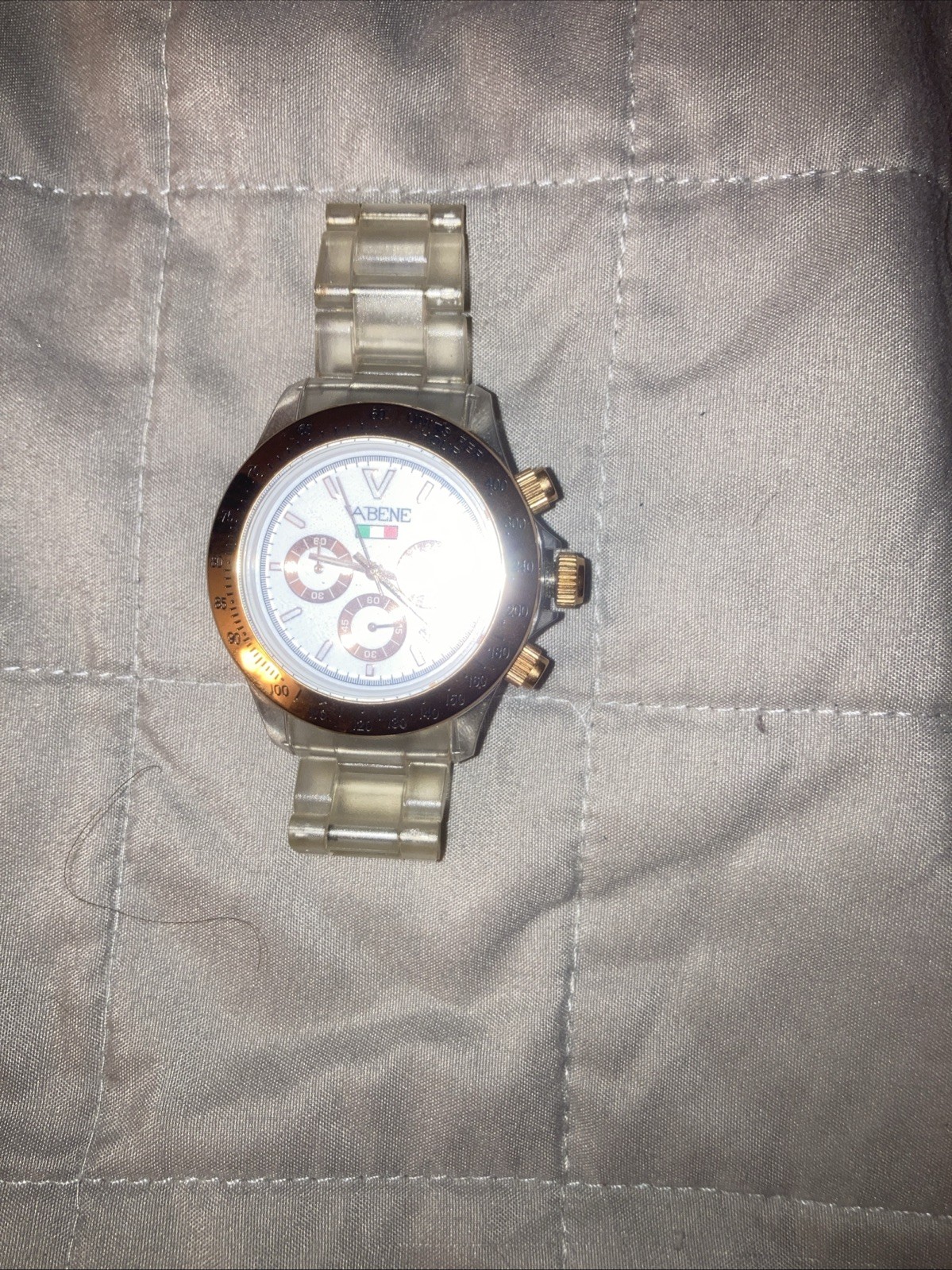 Vabene watch with a gold-tone bezel and a clear plastic or polycarbonate strap