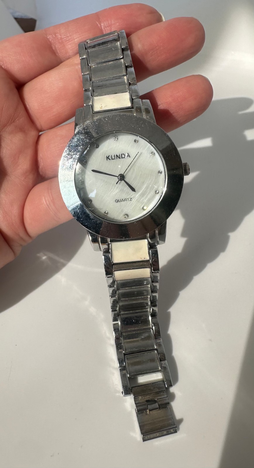 Used Kunda quartz watch a silver-tone metal band and a white dial needs Battery