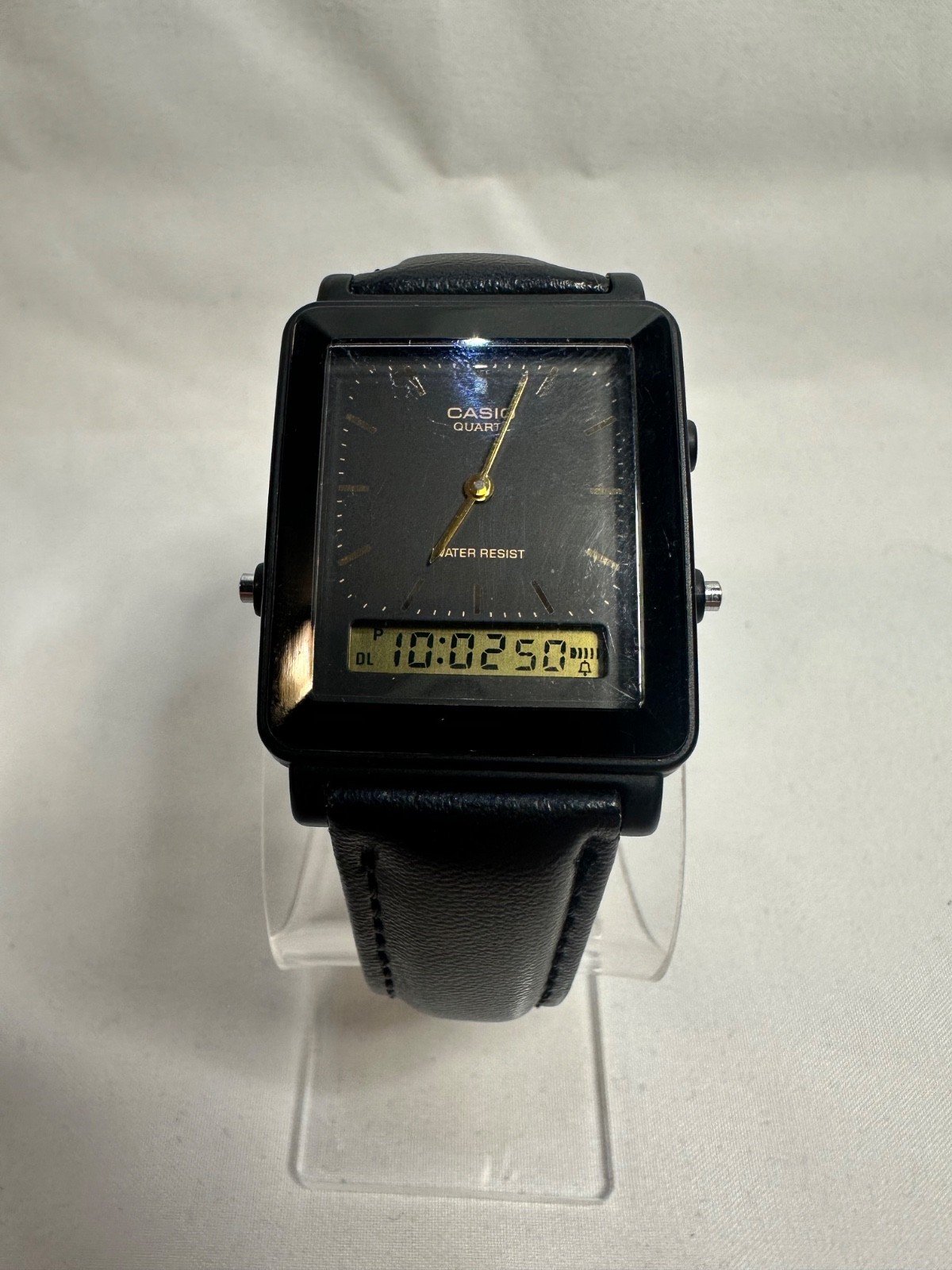 VINTAGE CASIO AQ-30 black face with gold accent leather band