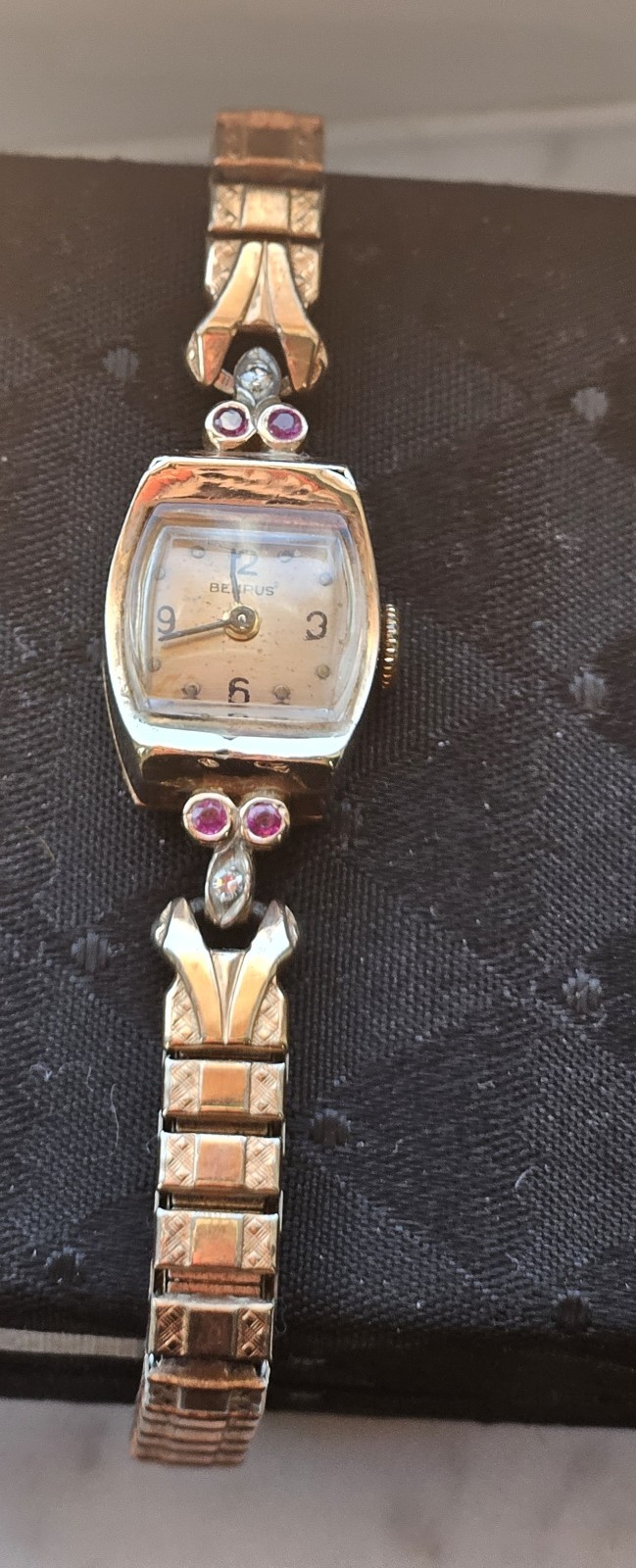 VINTAGE 14 KT BENRUS ROSEGOLD LADIES WATCH WITH RUBIES AND DIAMONDS.