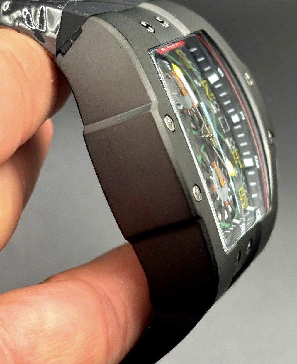 The Invicta 48027 men’s wristwatch features a striking black bezel and case