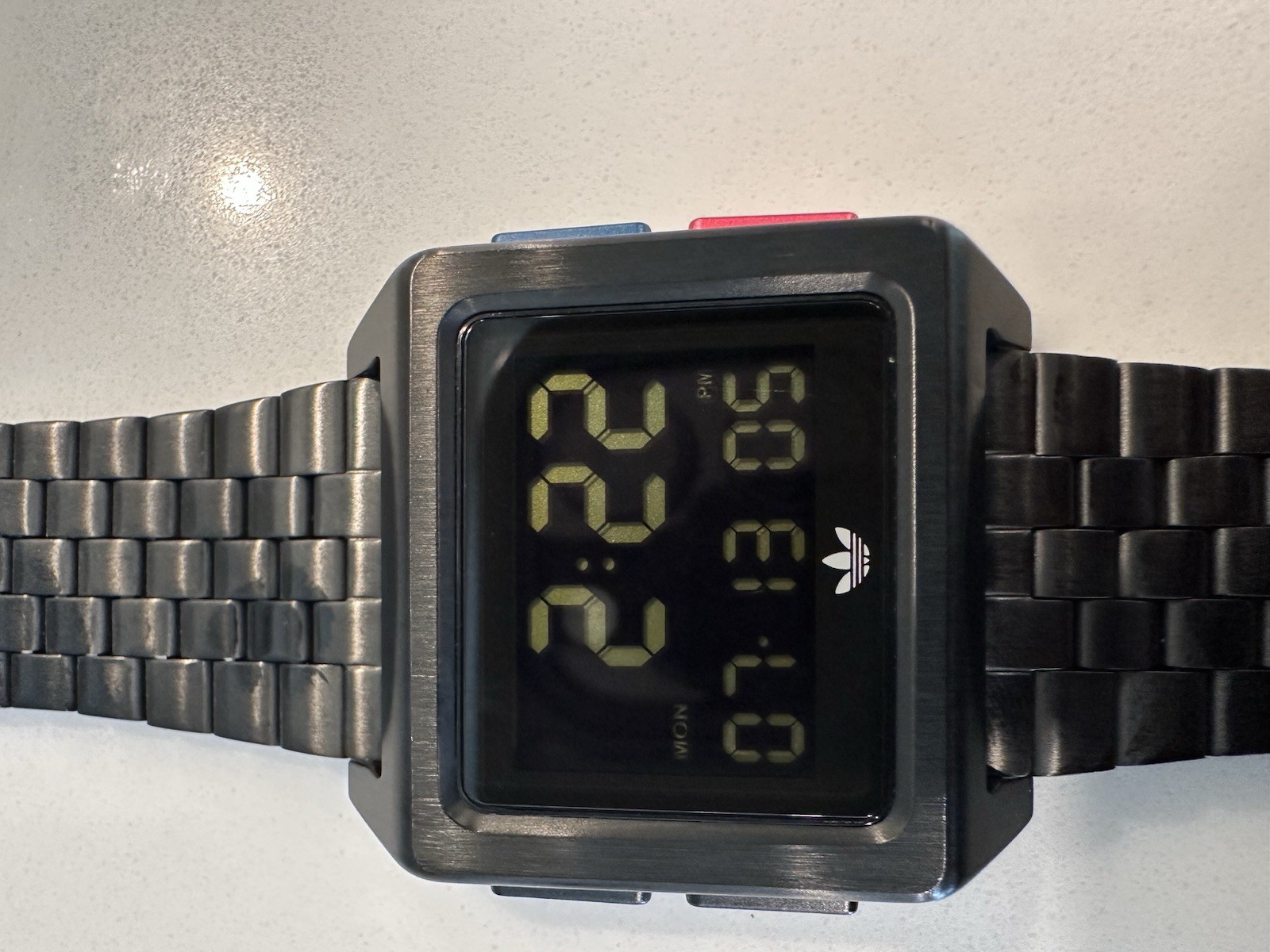 Adidas Archive M1 watch with a matte black finish and a square digital display