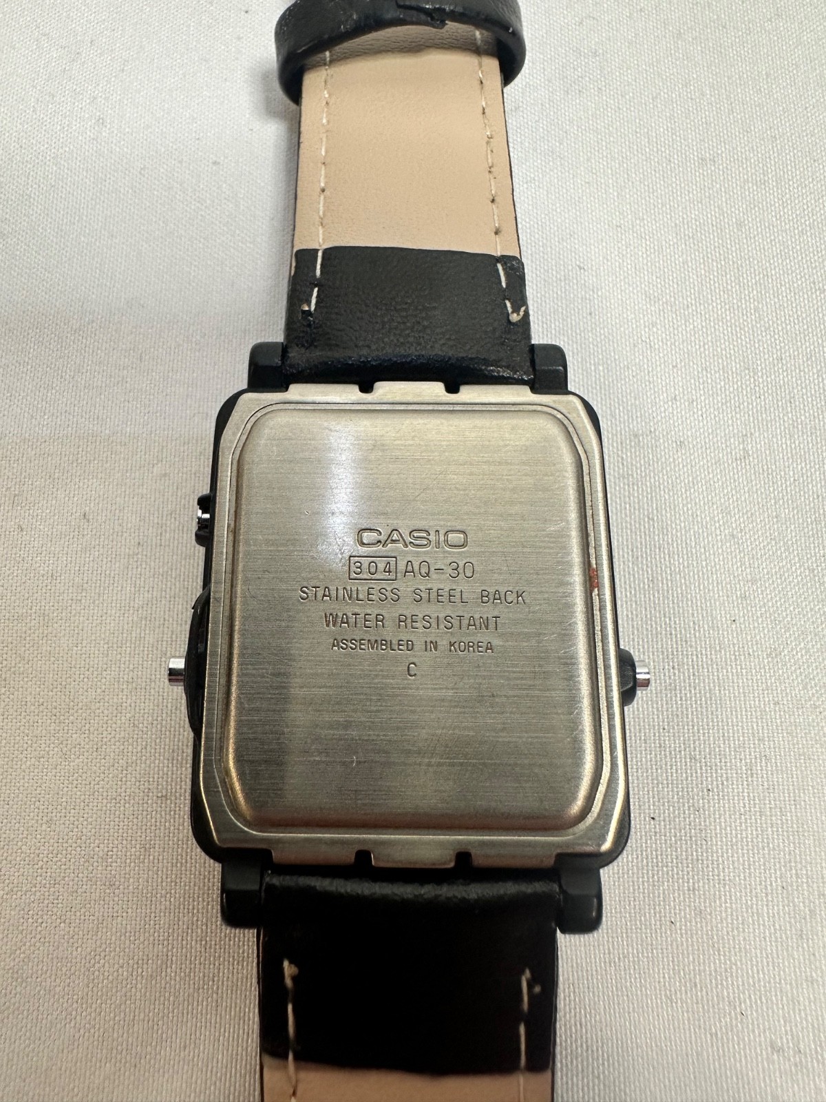 VINTAGE CASIO AQ-30 black face with gold accent leather band