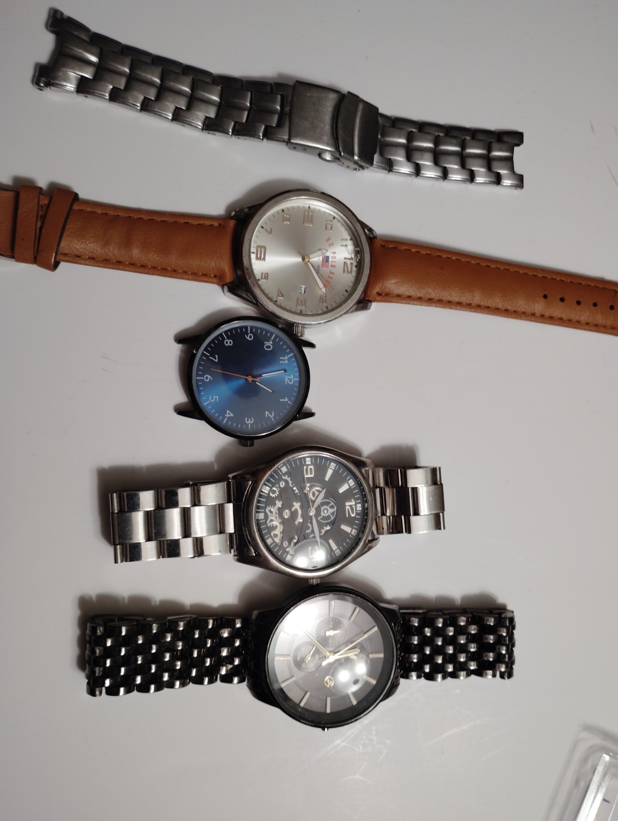 Collection of four fashion watches with various strap styles