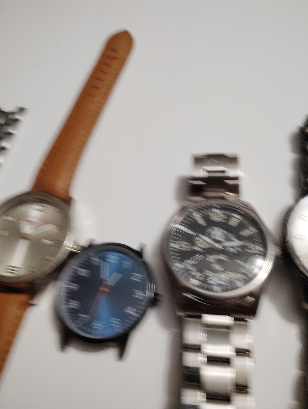 Collection of four fashion watches with various strap styles