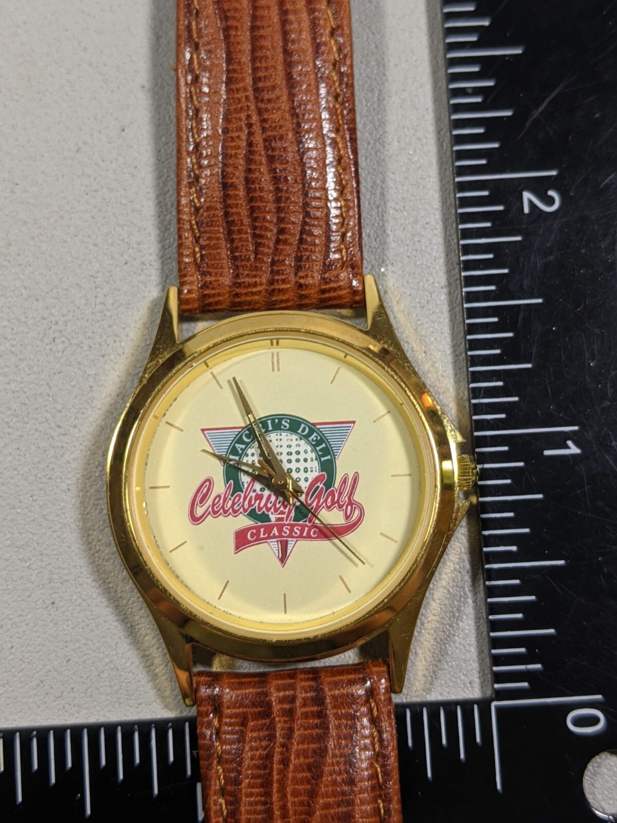 Macri’s Deli Celebrity Golf Classic Round Gold Tone Case 33 mm Leather Bnd Watch