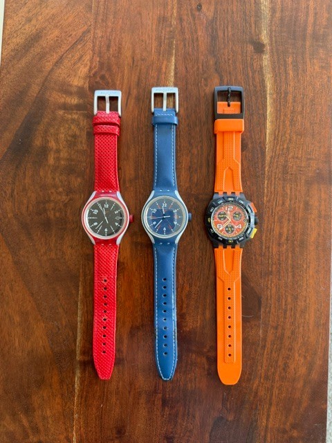 swatch watches mens, red, blue, orange bands. No scratches on crystals.