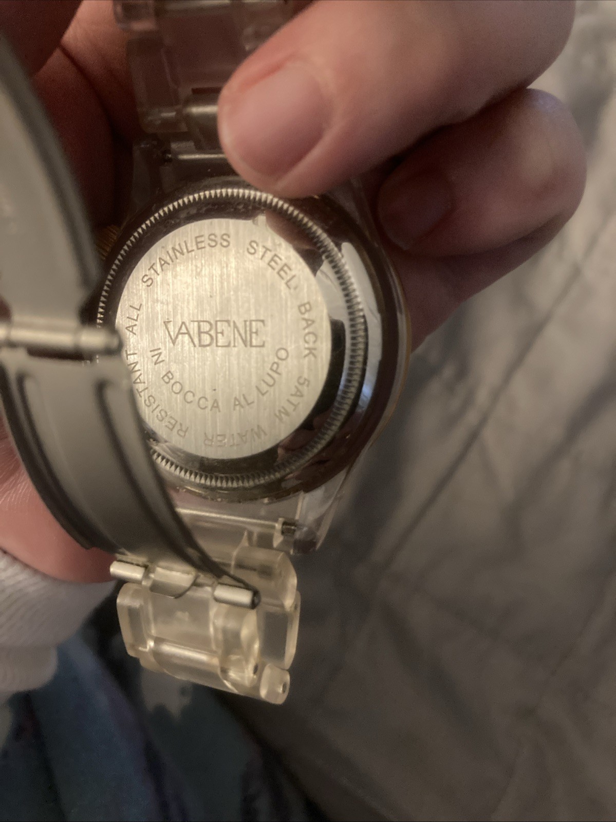 Vabene watch with a gold-tone bezel and a clear plastic or polycarbonate strap