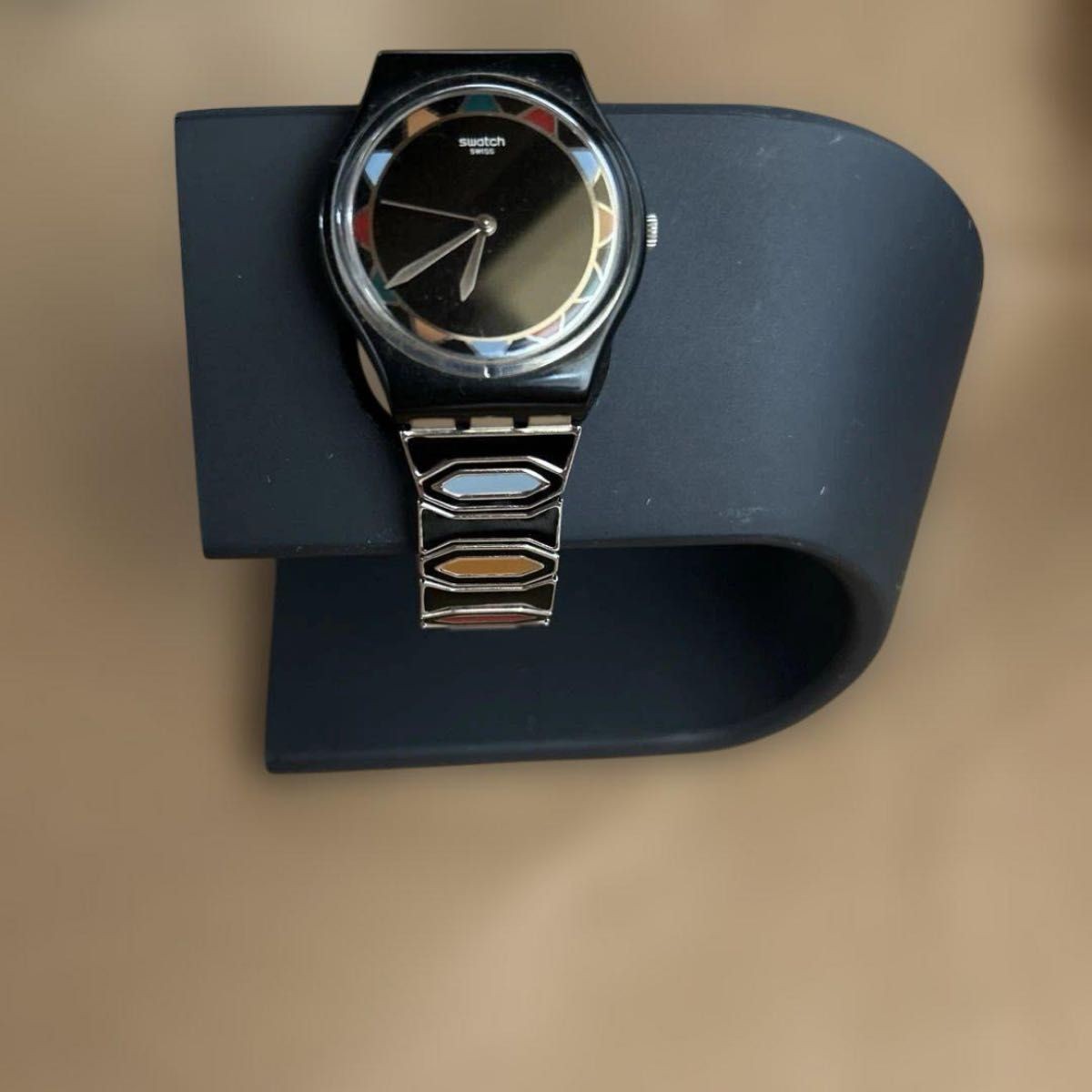 Swatch watch with black dial and multicolor bezel