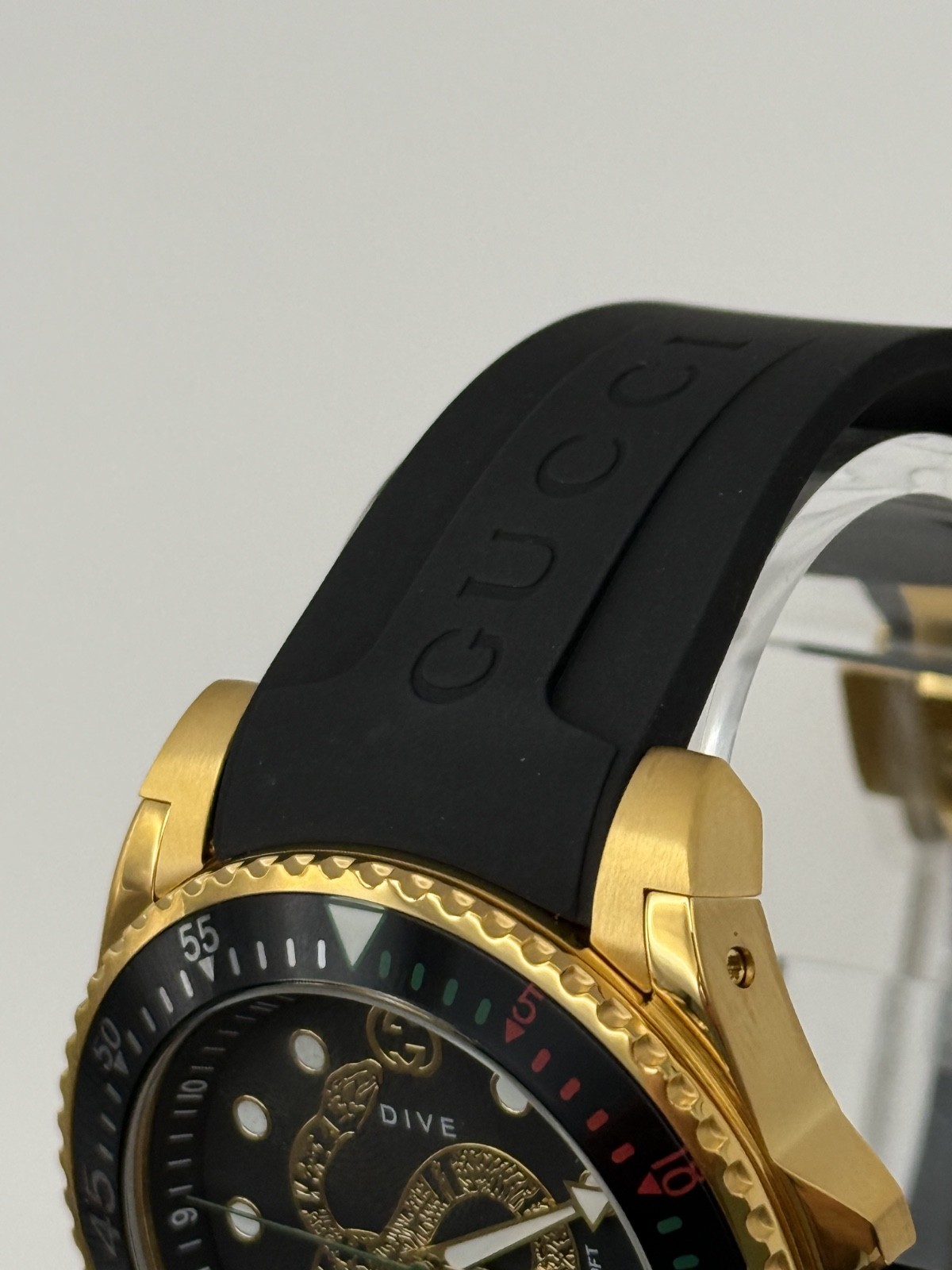 Gucci Dive Black Dial Gold-Tone Rubber Strap 45mm. Men’s Watch YA136219