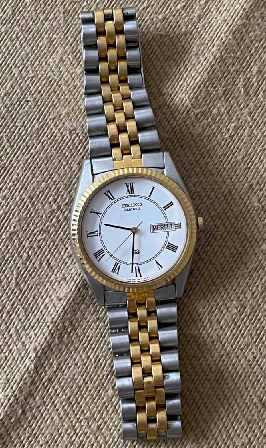 Seiko Quartz Two-Tone Stainless Bracelet Roman White Dial Day/Date Dress Watch