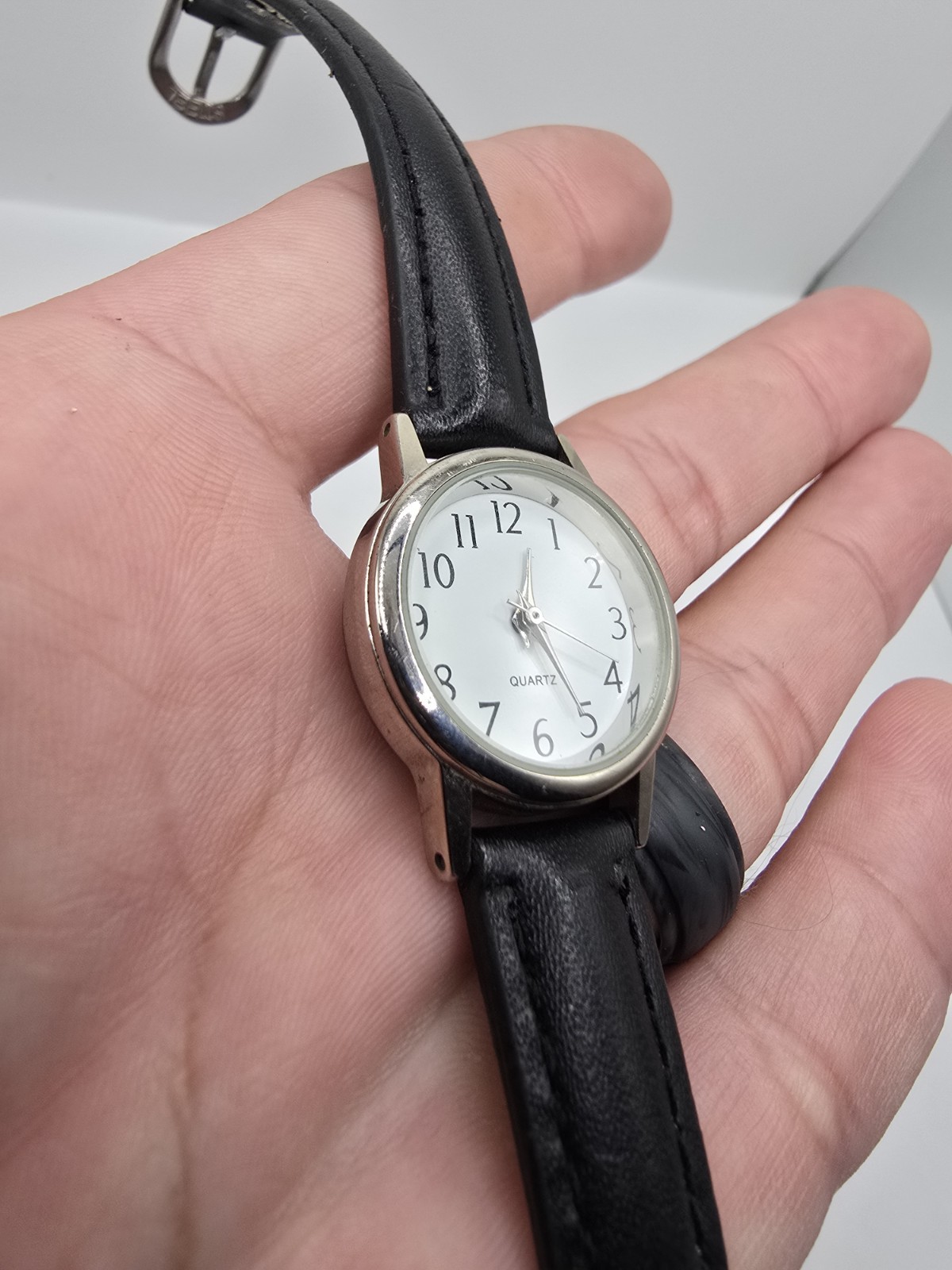 Accutime Quartz Analog Wristwatch White Dial Arabic Numerals Silver Case 26mm