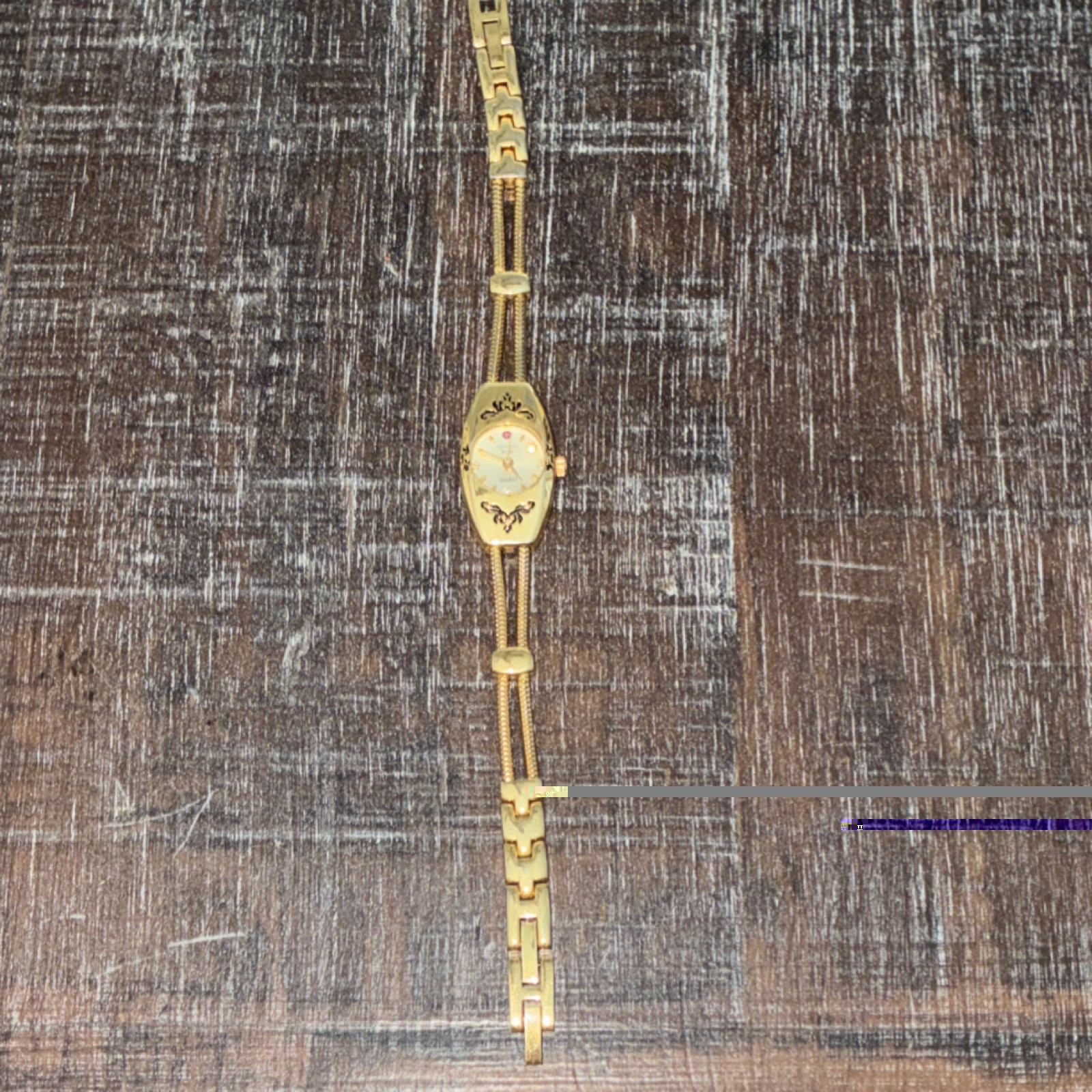 Genuine Ruby Women’s Gold Tone Oval Gemmed Bracelet Watch, Quartz Analog