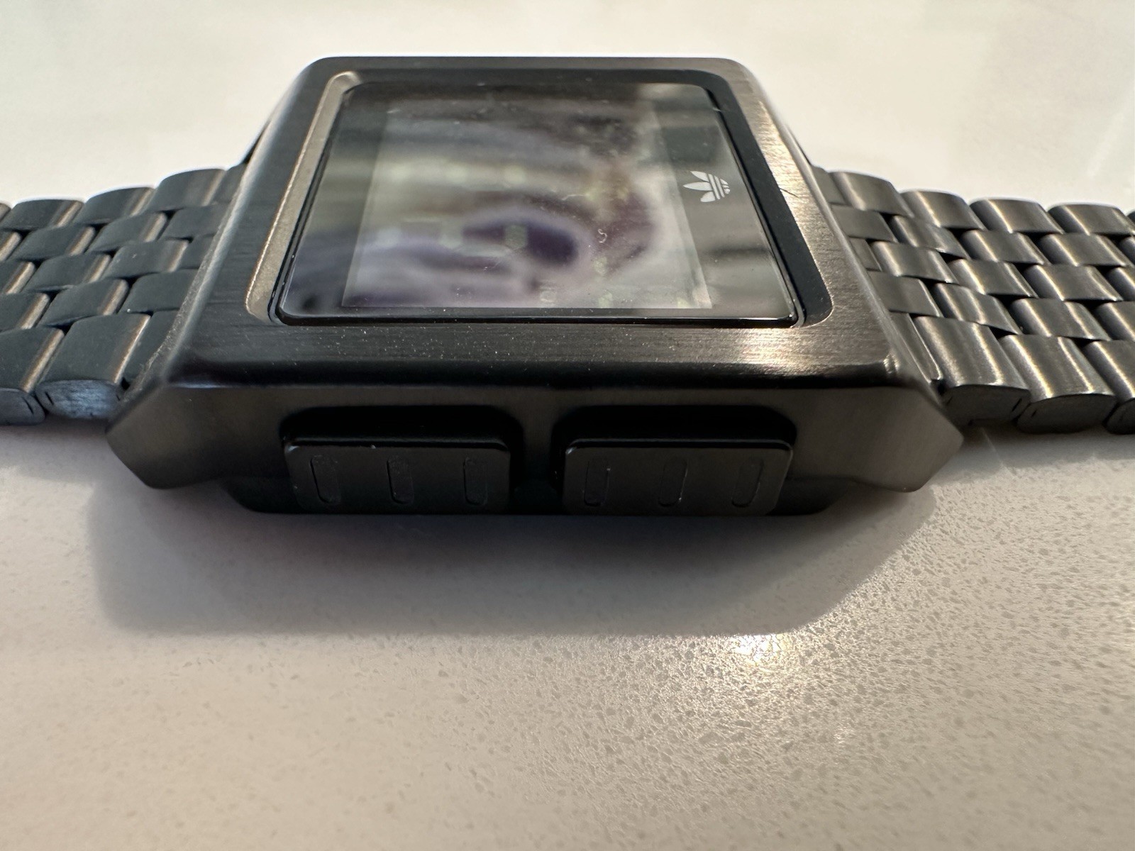 Adidas Archive M1 watch with a matte black finish and a square digital display