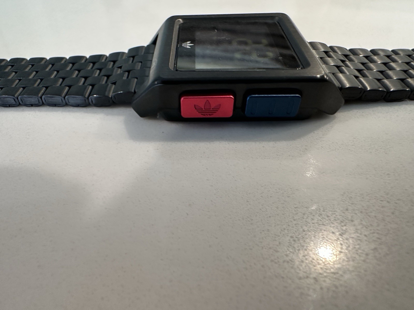 Adidas Archive M1 watch with a matte black finish and a square digital display