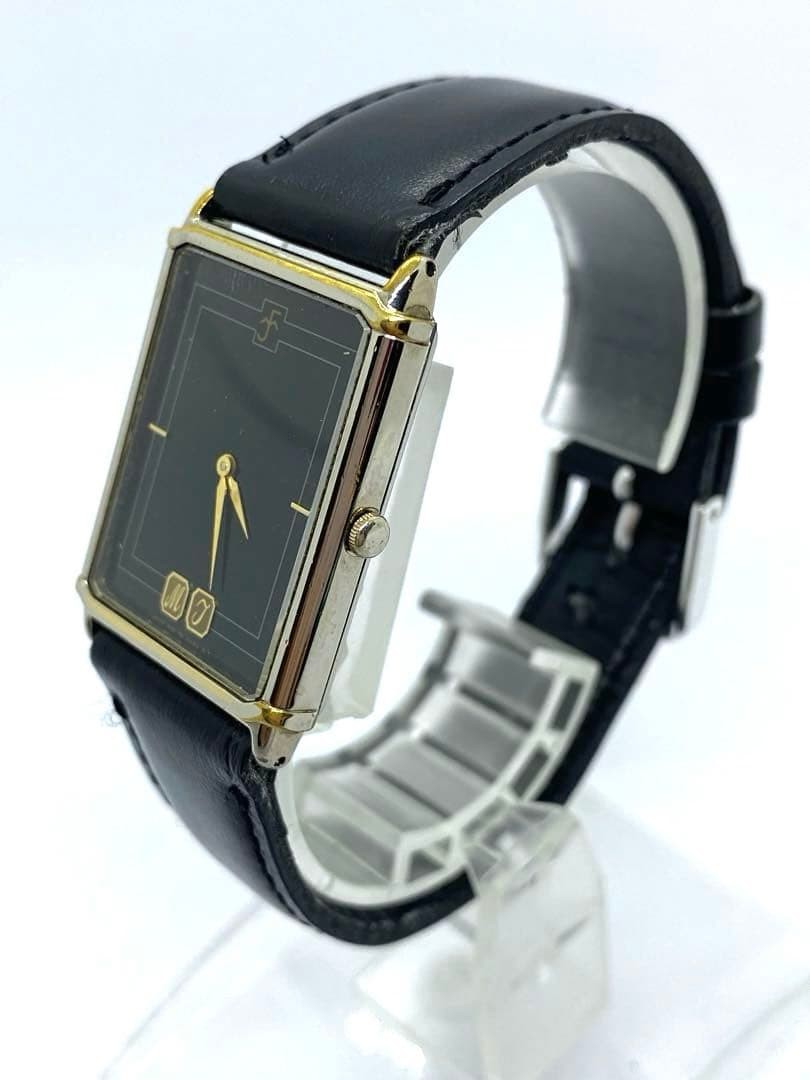 SEIKO rectangular quartz watch with black leather strap.