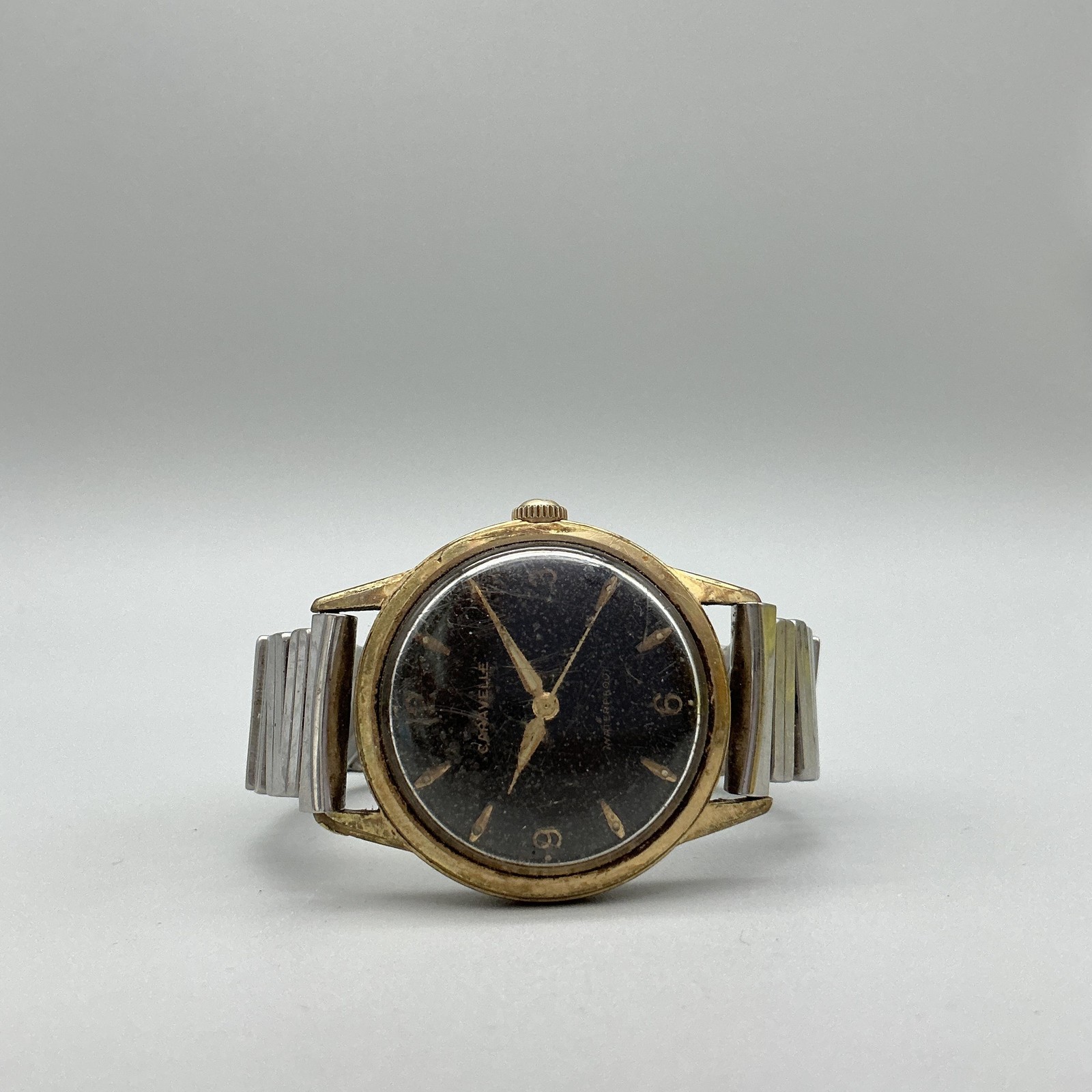 Vintage Caravelle Mens Watch 33mm Black Dial Gold Tone Stretch Band Manual Wind