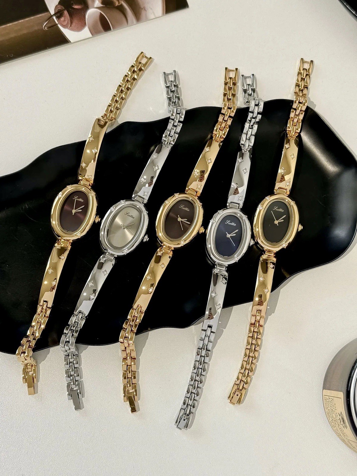 Elegant Gold Oval Ladies Luxury Watch with Dark Brown Maroon Dial & Star Accents