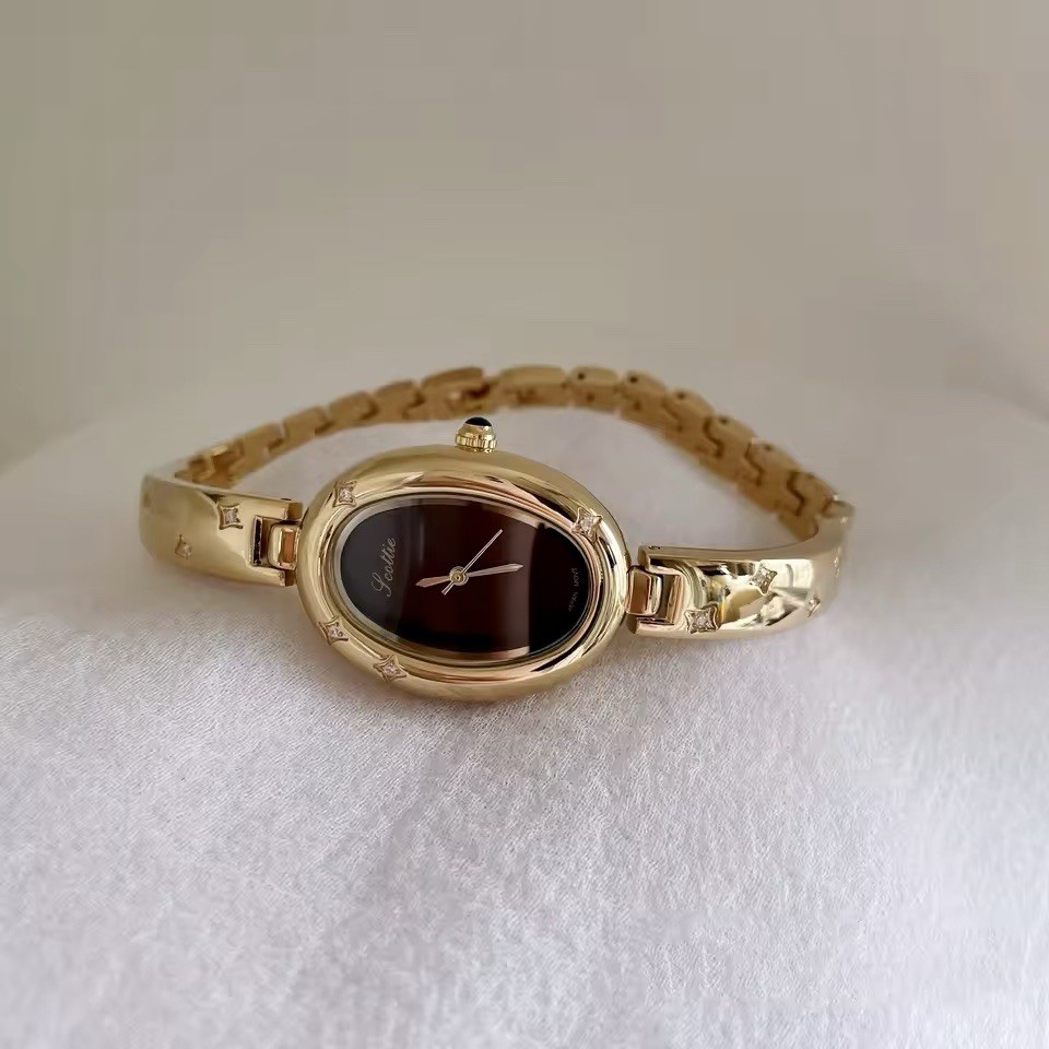 Elegant Gold Oval Ladies Luxury Watch with Dark Brown Maroon Dial & Star Accents