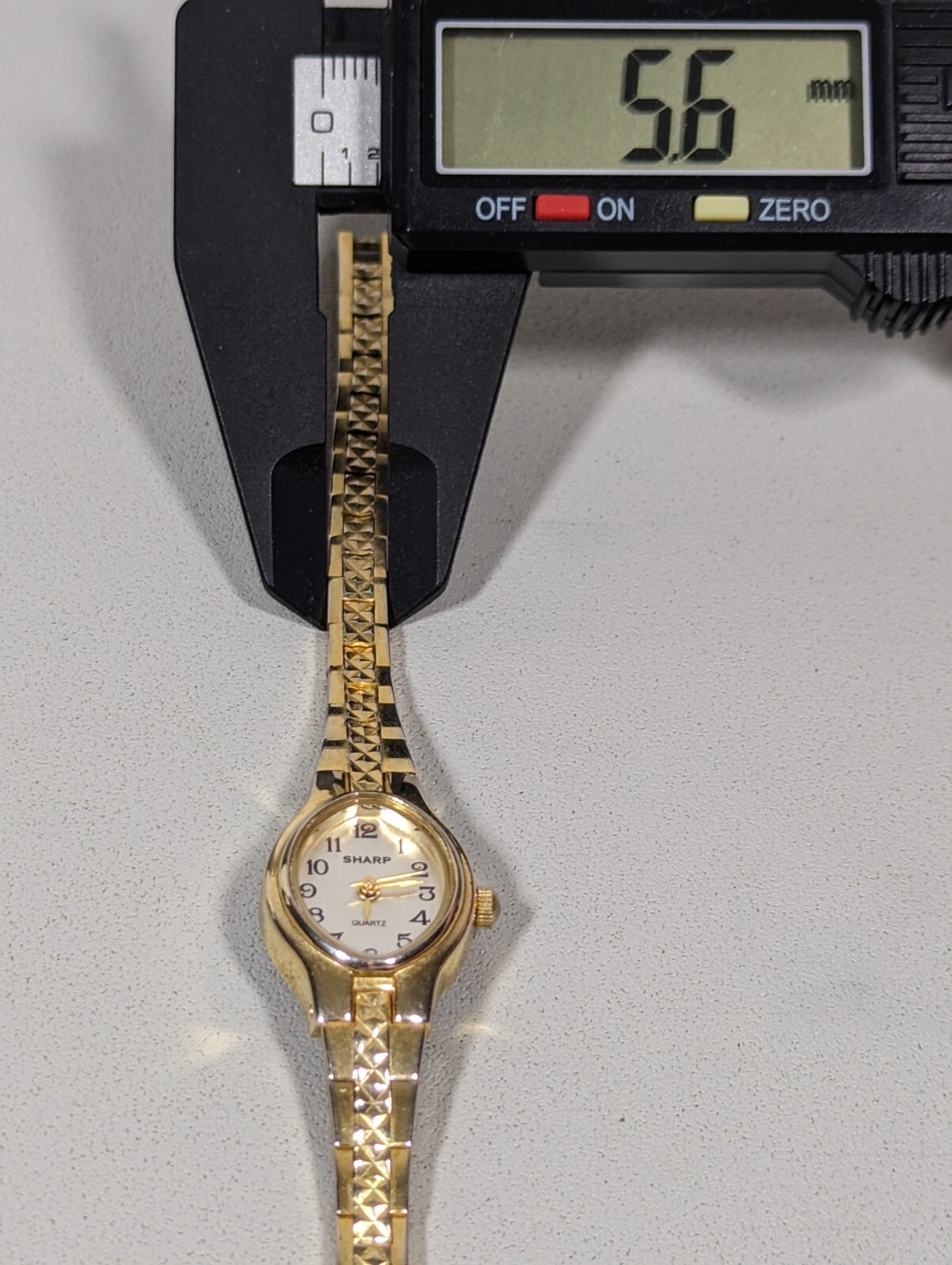 Sharp Womans Silver Dial GoldTone Oval Case Textured Bracelet Band Watch 6.75 in