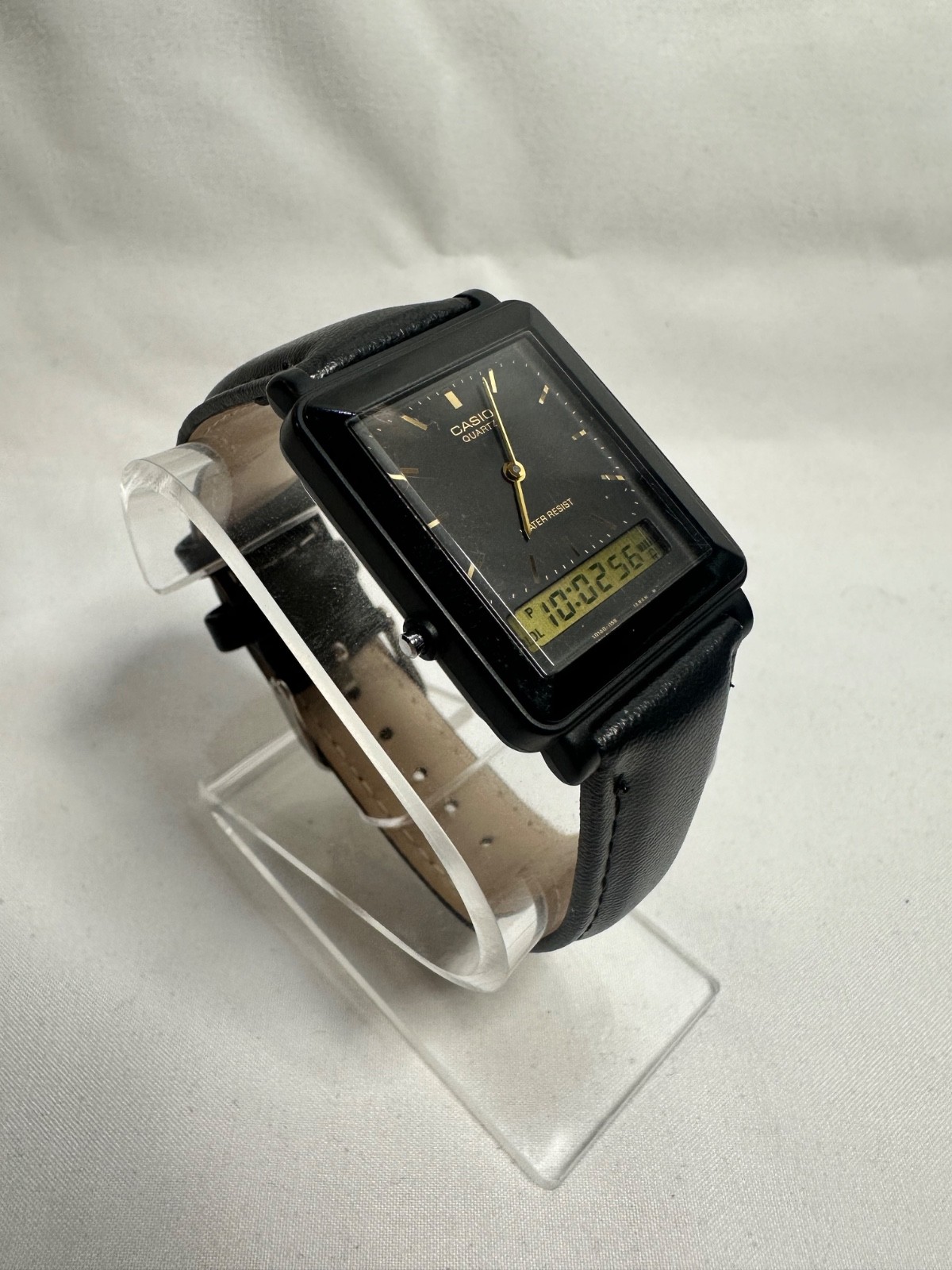 VINTAGE CASIO AQ-30 black face with gold accent leather band
