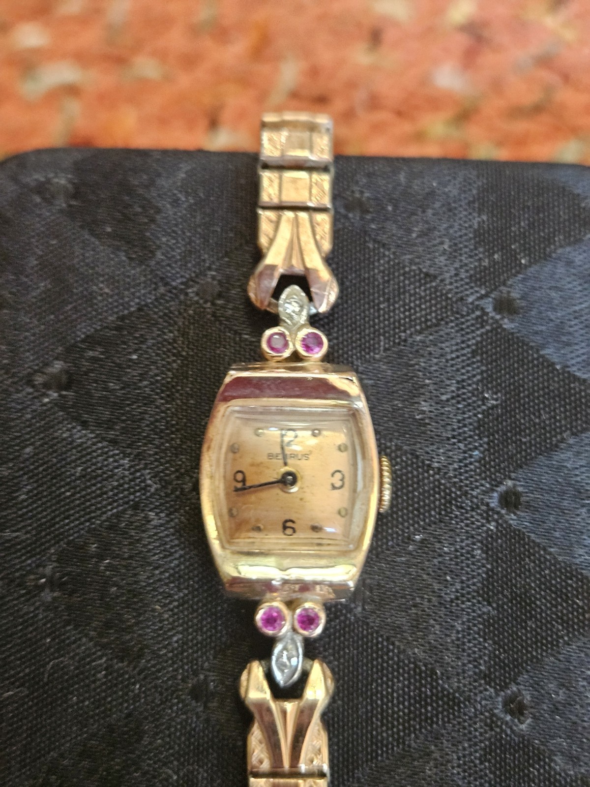 VINTAGE 14 KT BENRUS ROSEGOLD LADIES WATCH WITH RUBIES AND DIAMONDS.