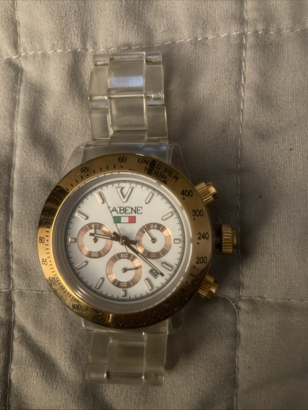 Vabene watch with a gold-tone bezel and a clear plastic or polycarbonate strap