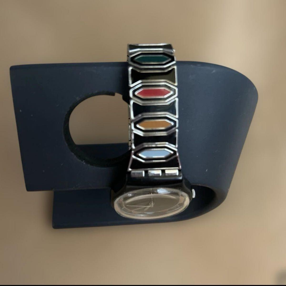 Swatch watch with black dial and multicolor bezel