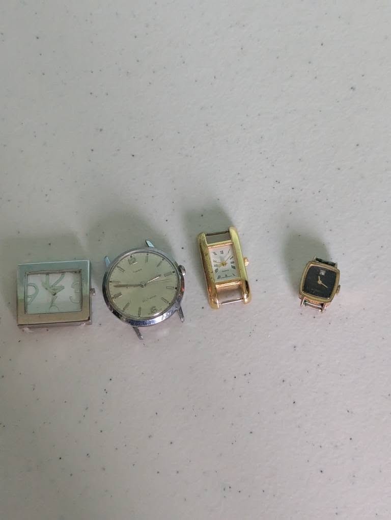 Lot of 4 watches no bands not tested for parts or repair
