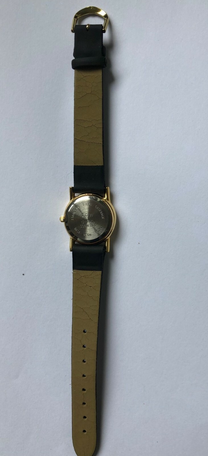 Ladies Avon 101 gold tone dress watch,ivory face,gold hands,black strap.