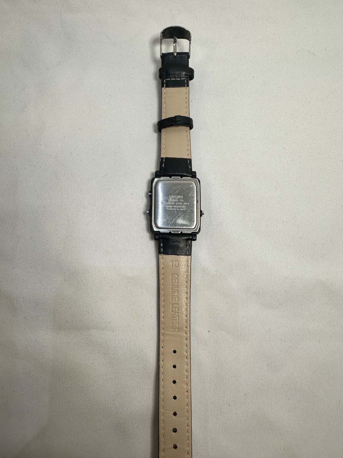VINTAGE CASIO AQ-30 black face with gold accent leather band