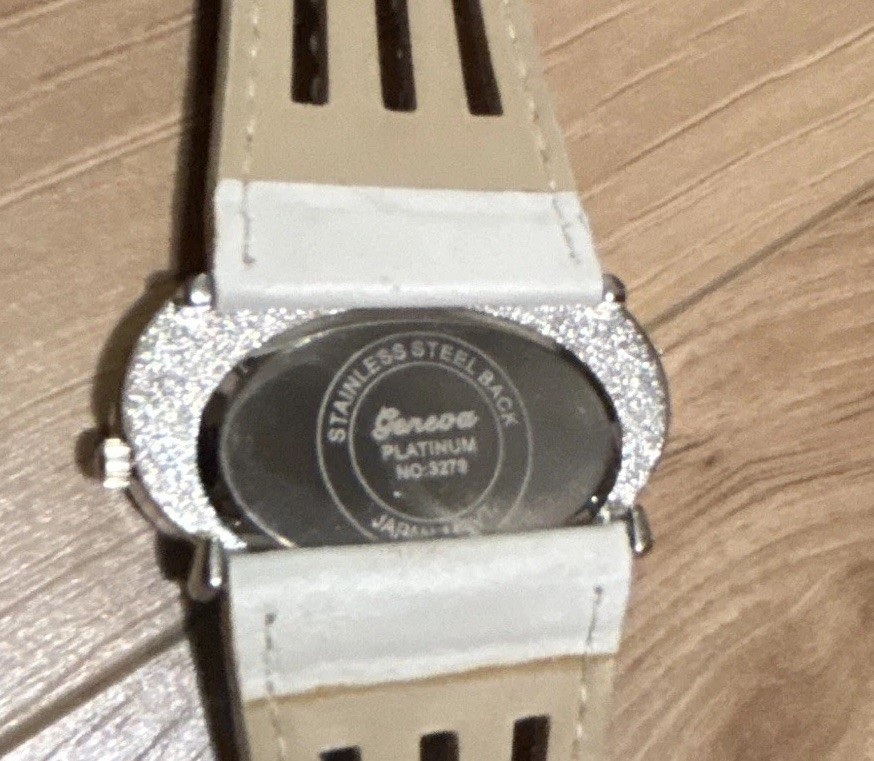 GENEVA PLATINUM WOMEN’S QUARTZ OVAL ANALOG WHITE FAUX STRAP SILVER RHINESTONE