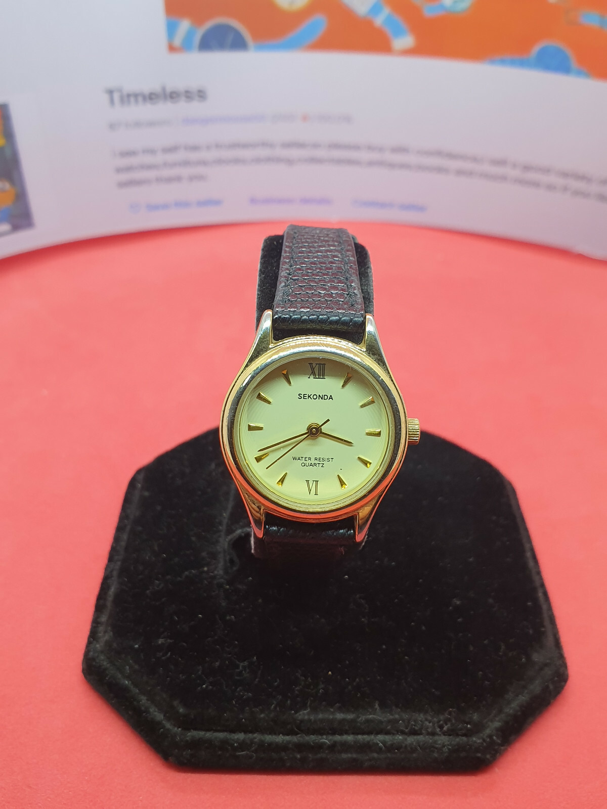 ladies sekonda gold tone watch,ivory face,gold hands,black leather strap.#181.