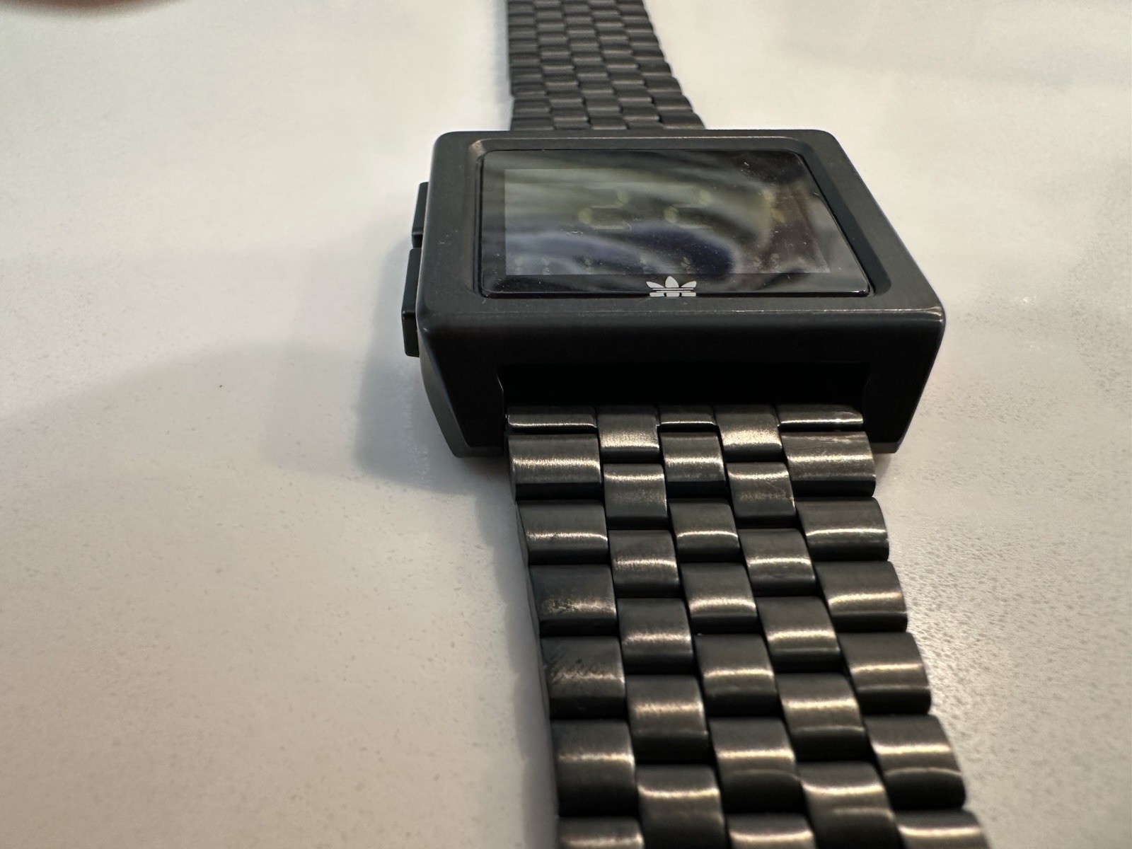 Adidas Archive M1 watch with a matte black finish and a square digital display