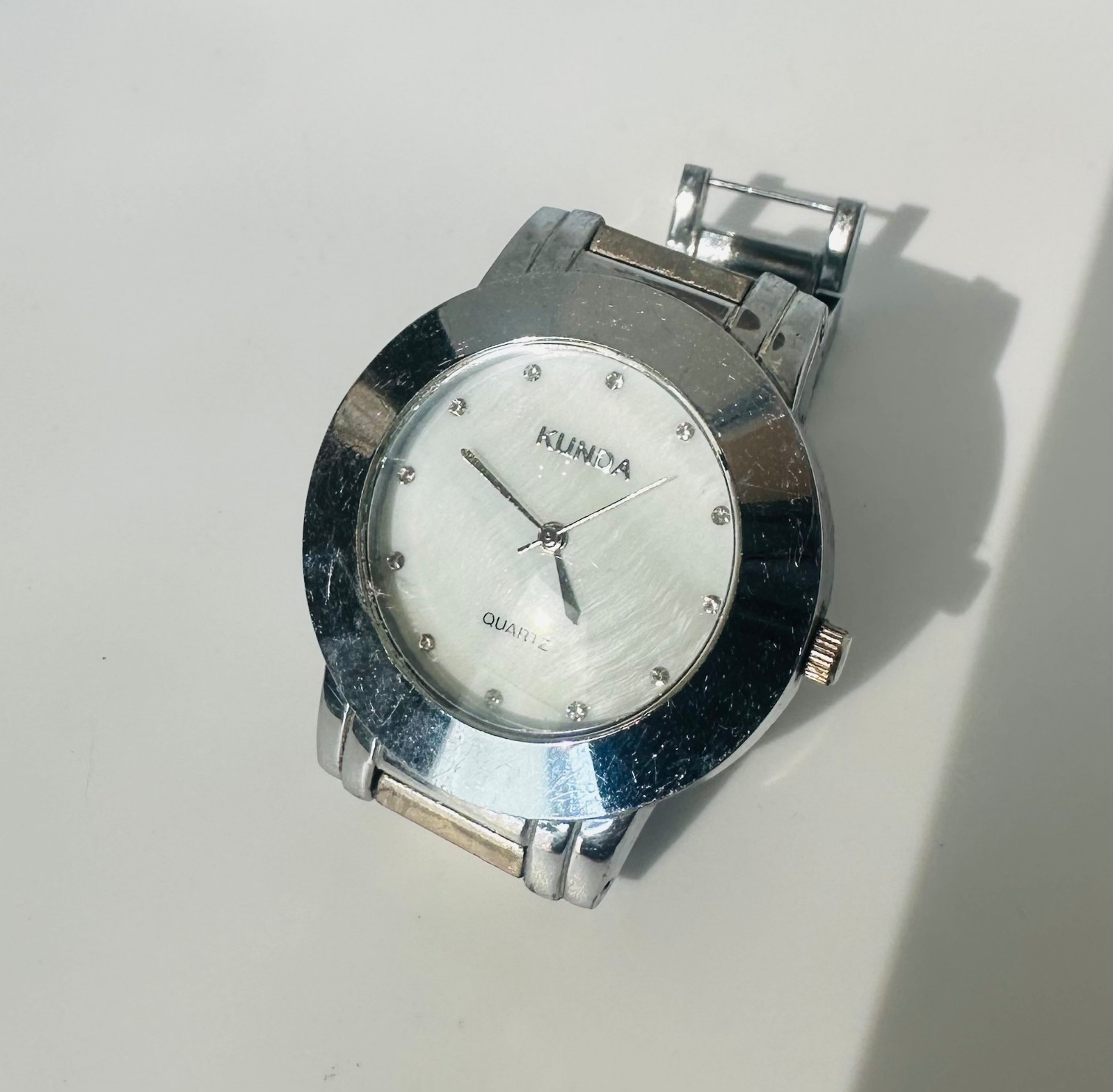 Used Kunda quartz watch a silver-tone metal band and a white dial needs Battery