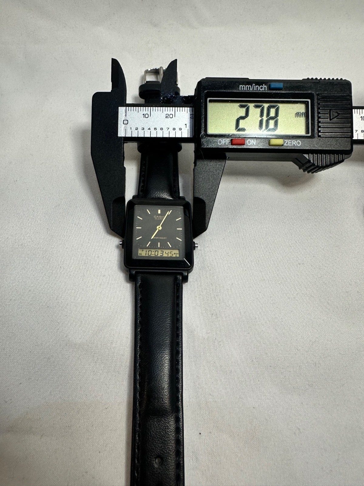 VINTAGE CASIO AQ-30 black face with gold accent leather band