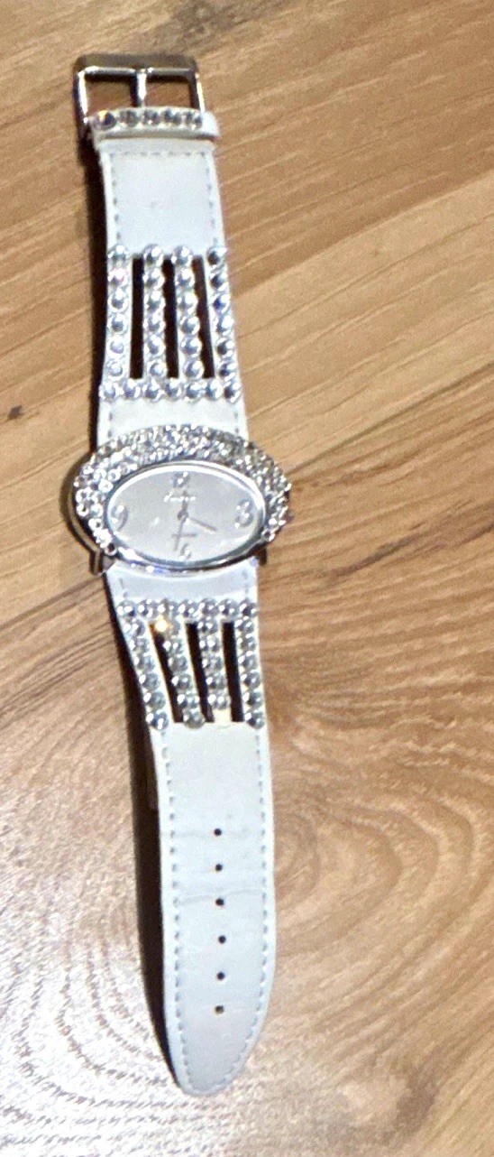 GENEVA PLATINUM WOMEN’S QUARTZ OVAL ANALOG WHITE FAUX STRAP SILVER RHINESTONE