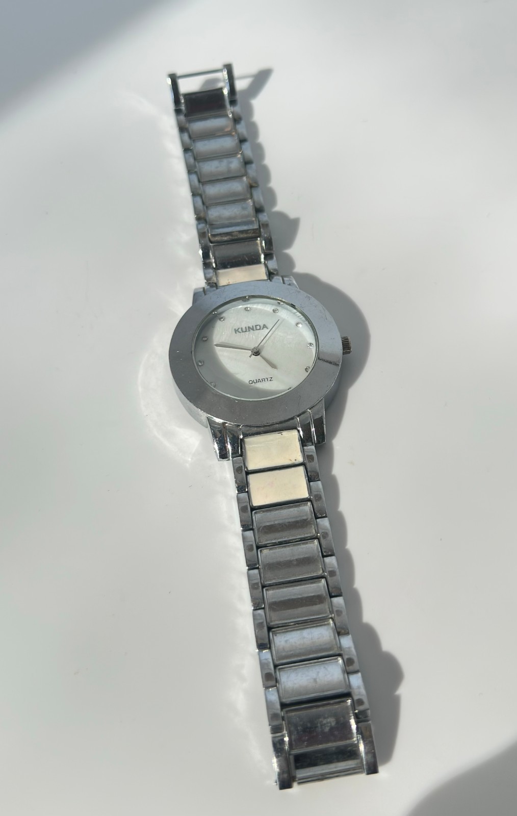 Used Kunda quartz watch a silver-tone metal band and a white dial needs Battery