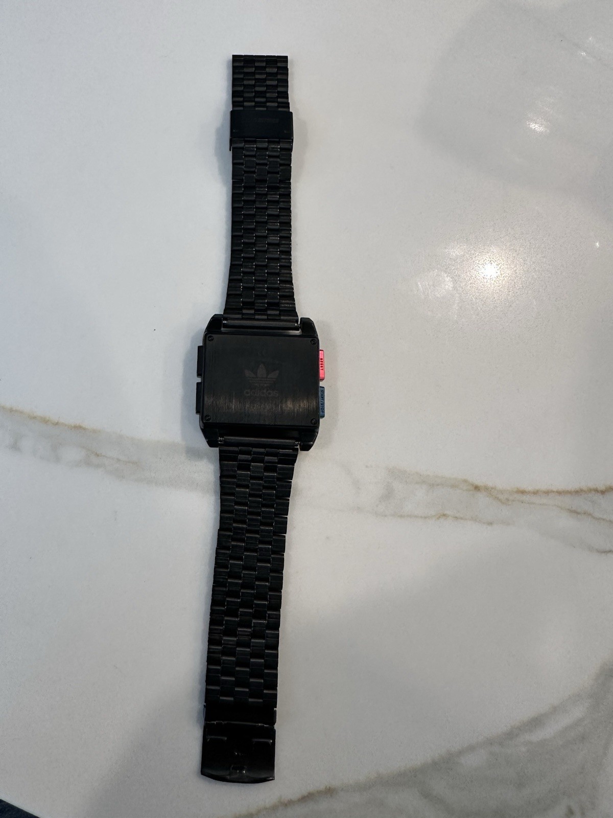 Adidas Archive M1 watch with a matte black finish and a square digital display