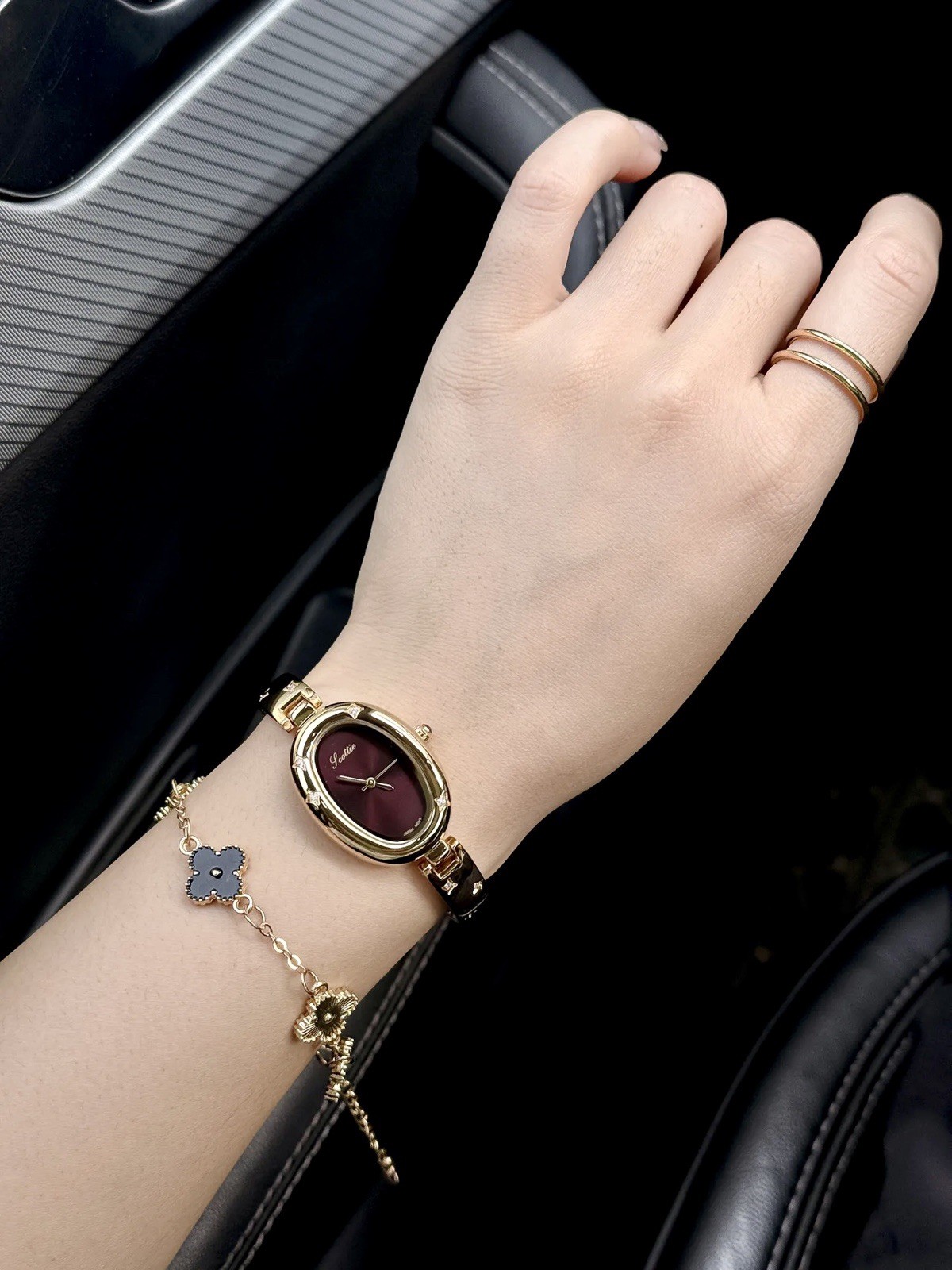 Elegant Gold Oval Ladies Luxury Watch with Dark Brown Maroon Dial & Star Accents