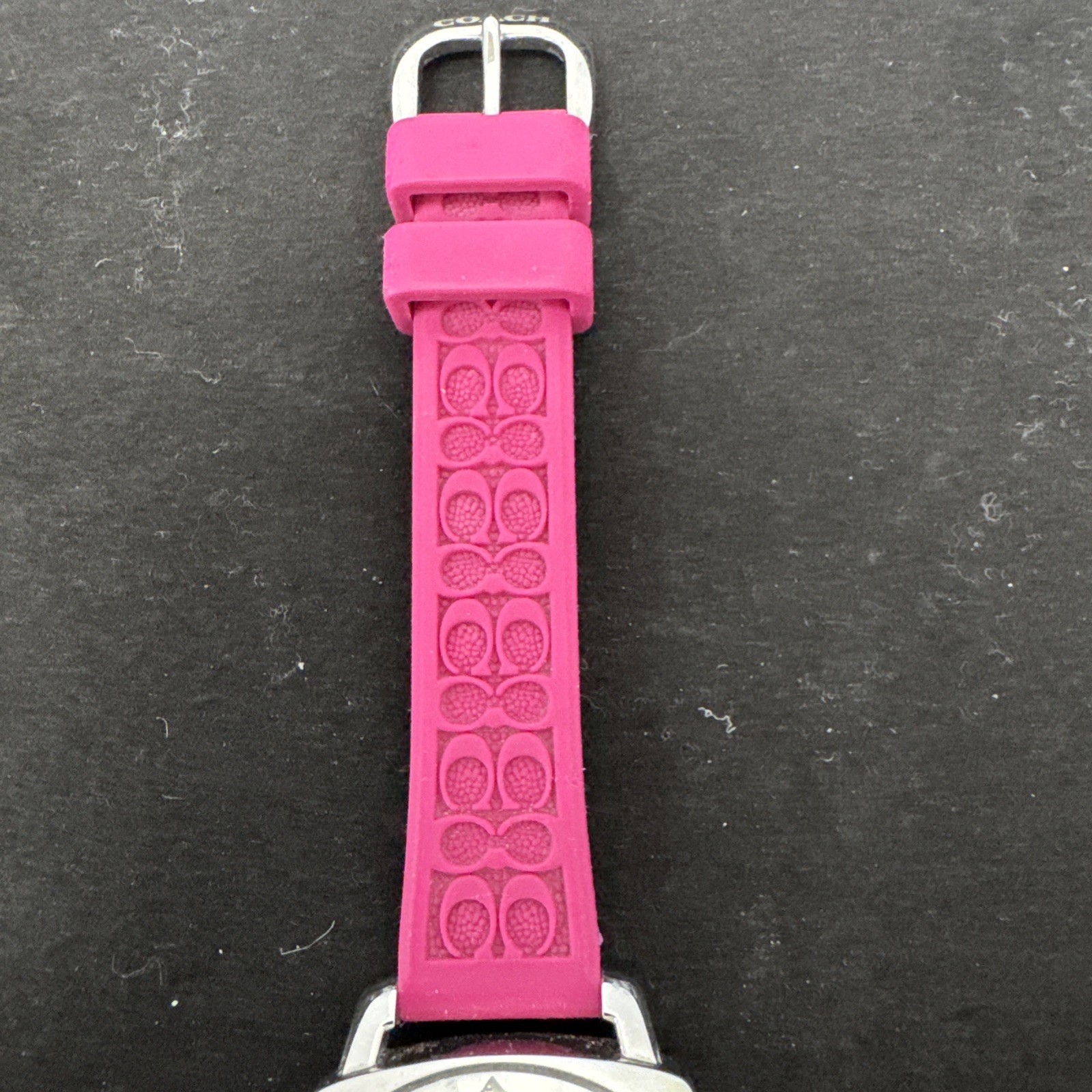 Coach Boyfriend watch featuring a vibrant pink logo-embossed silicone strap.