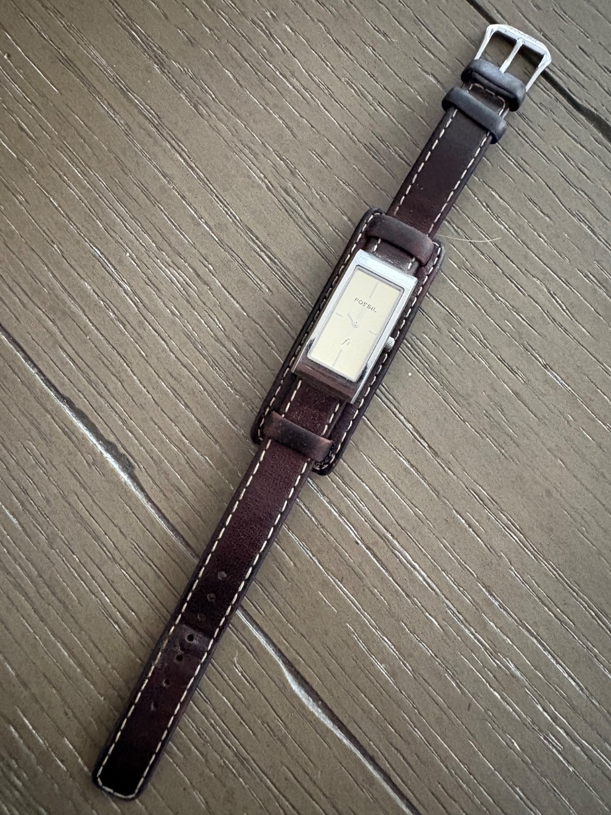 womens vintage fossil watch with silver rectangular face and brown leather strap